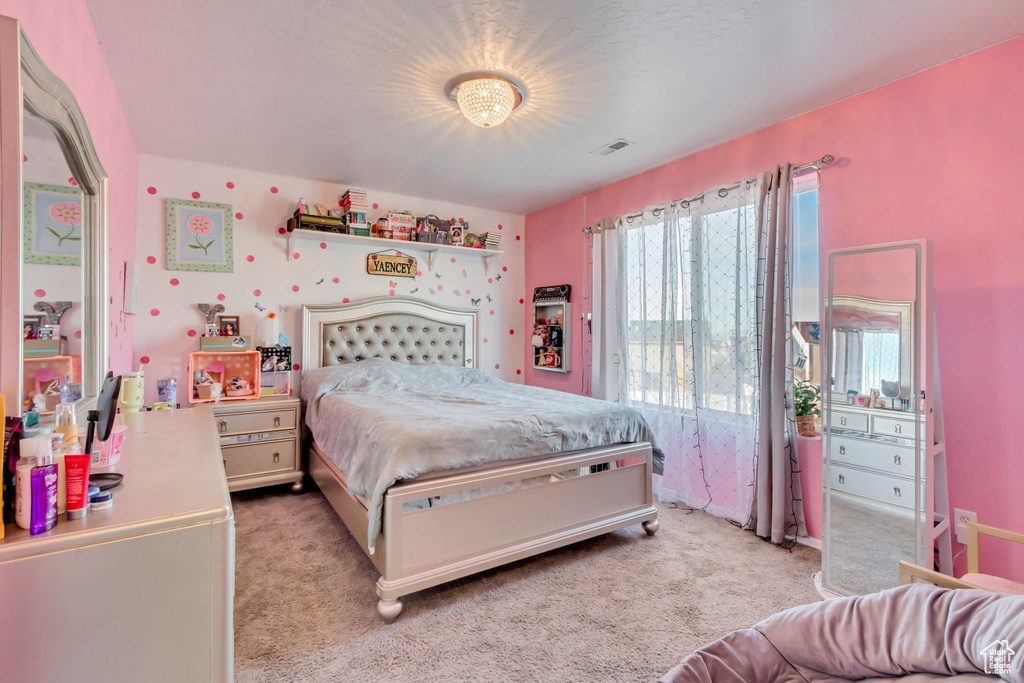 Bedroom with visible vents and light carpet