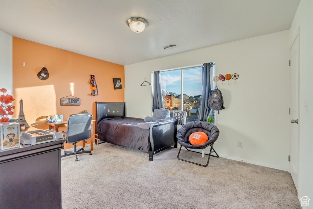 Bedroom with visible vents and carpet floors