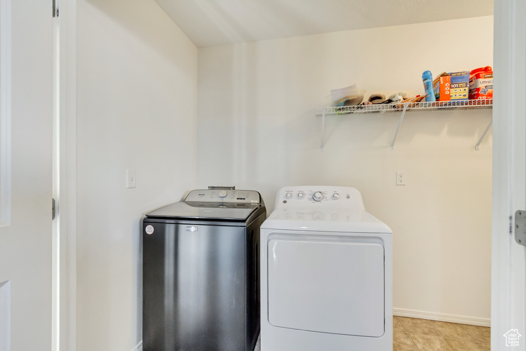 Laundry area with laundry area, washer and dryer, and baseboards