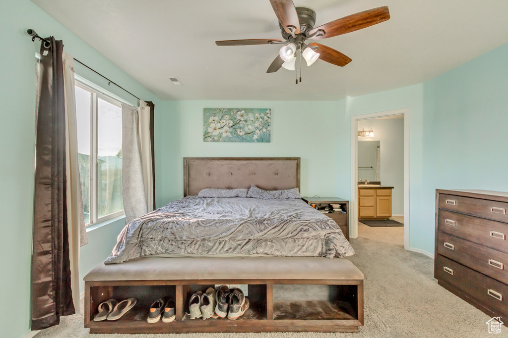 Bedroom featuring ensuite bath, carpet, baseboards, and ceiling fan