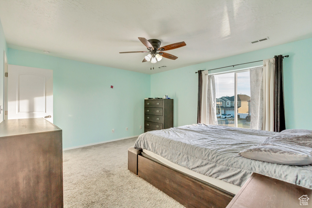Bedroom featuring visible vents, carpet flooring, a ceiling fan, and baseboards
