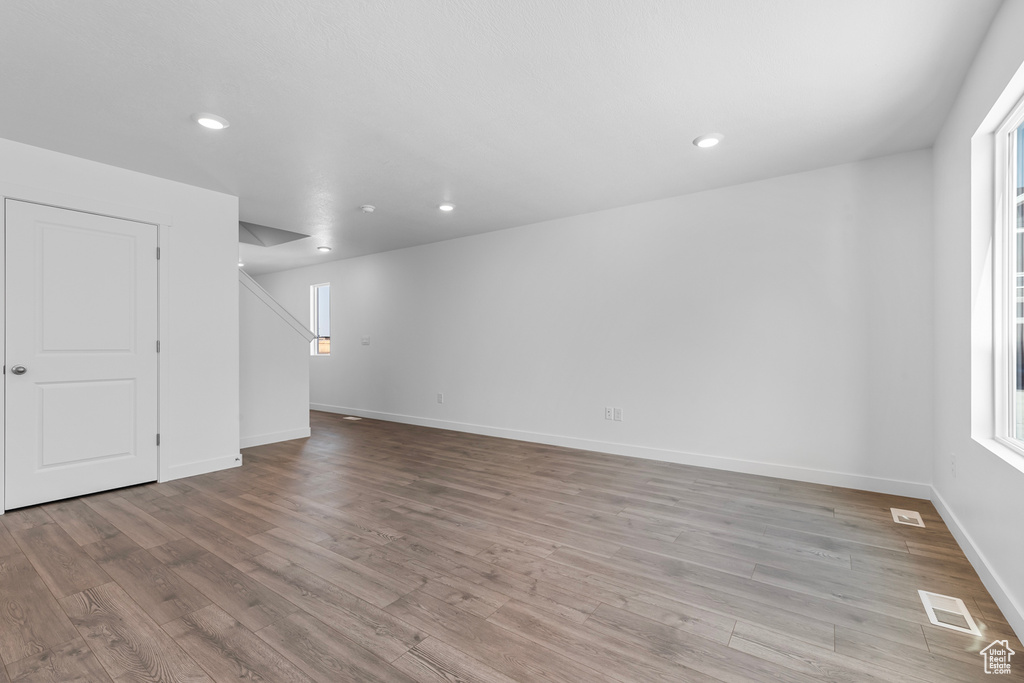 Spare room with recessed lighting, visible vents, and wood finished floors