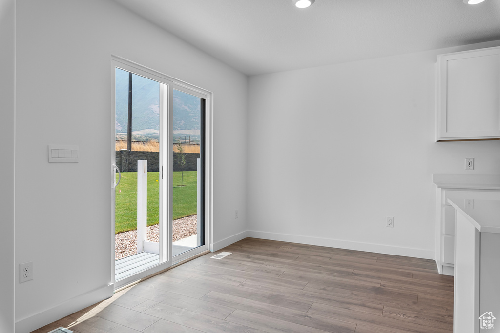 Unfurnished room featuring recessed lighting, baseboards, and light wood-style floors