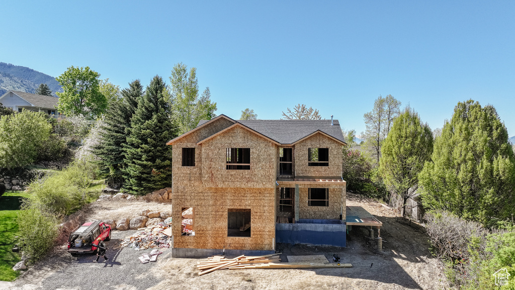Rear view of house with stone siding