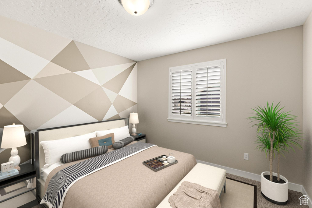 Bedroom with a textured ceiling, baseboards, and carpet floors