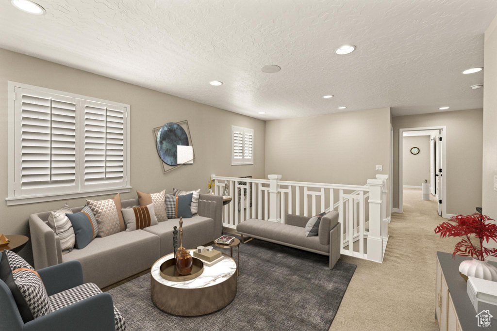 Carpeted living area featuring recessed lighting, baseboards, and a textured ceiling