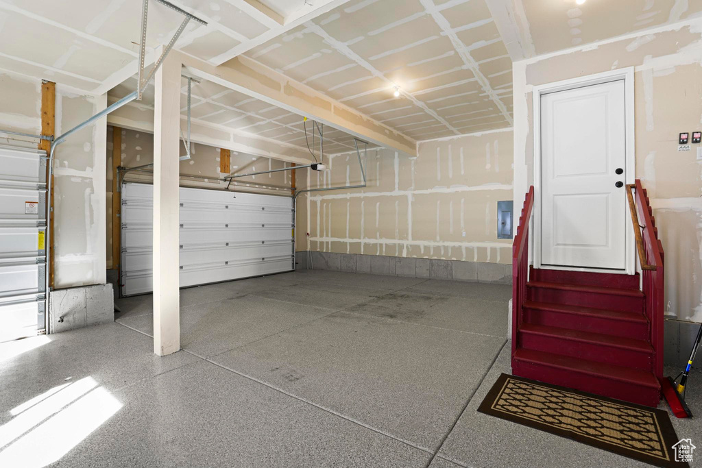 Garage with electric panel and a garage door opener