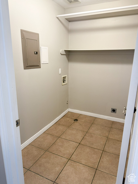 Laundry room featuring electric panel, washer hookup, tile patterned flooring, baseboards, and hookup for an electric dryer