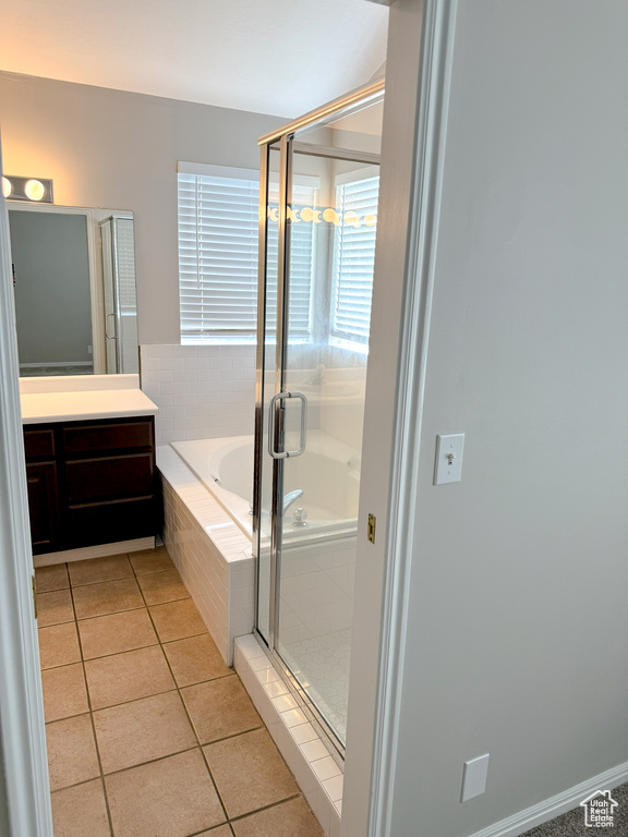 Bathroom featuring a shower stall, vanity, a bath, and tile patterned floors