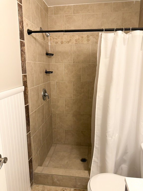Bathroom with tiled shower and toilet