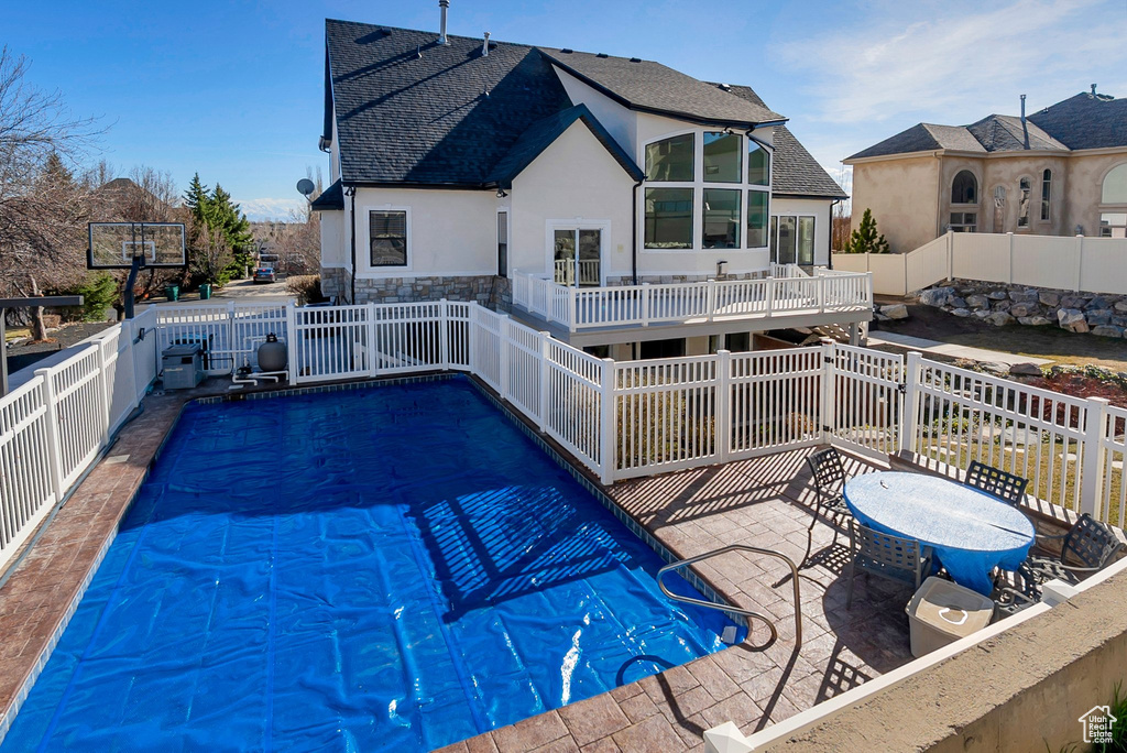 View of swimming pool featuring a fenced backyard, a patio, and a fenced in pool