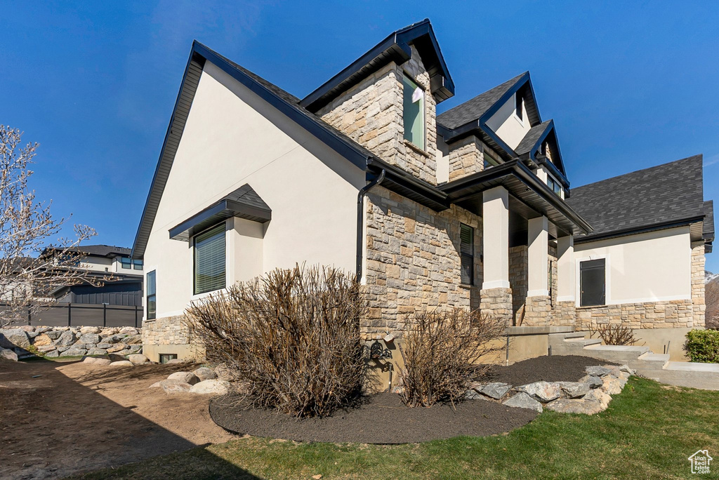 View of home's exterior with stucco siding and stone siding
