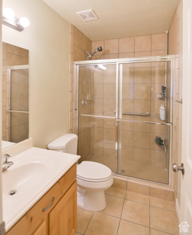 Bathroom with tile patterned floors, visible vents, toilet, a shower stall, and vanity