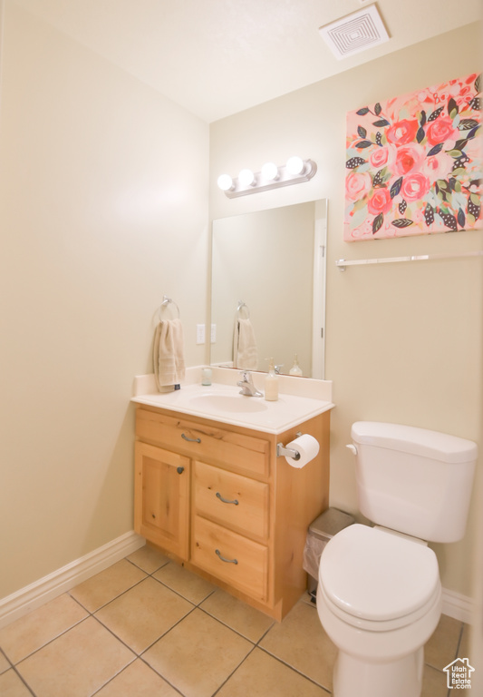 Bathroom with visible vents, toilet, tile patterned flooring, baseboards, and vanity