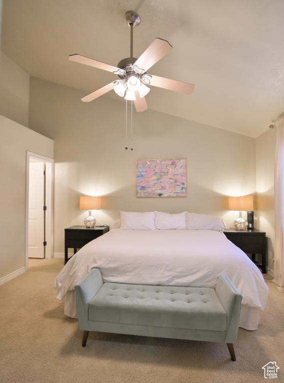 Carpeted bedroom featuring baseboards, lofted ceiling, and a ceiling fan