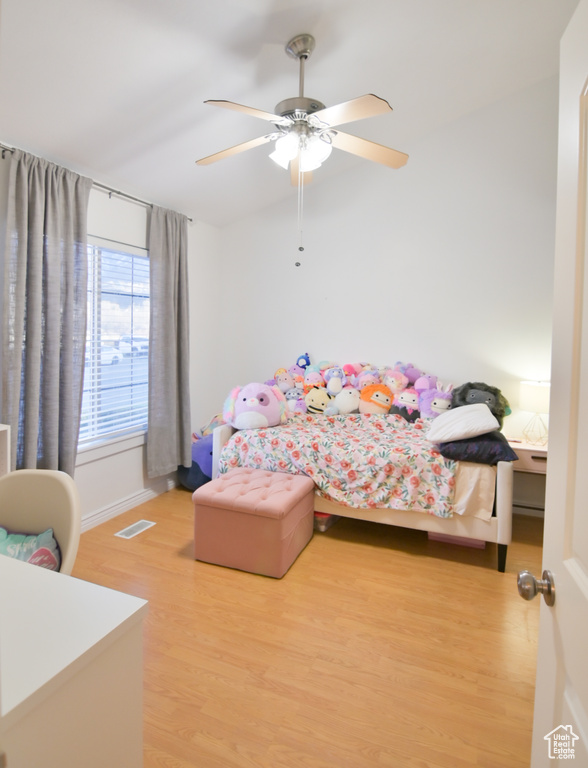 Bedroom featuring visible vents, light wood-style flooring, and ceiling fan