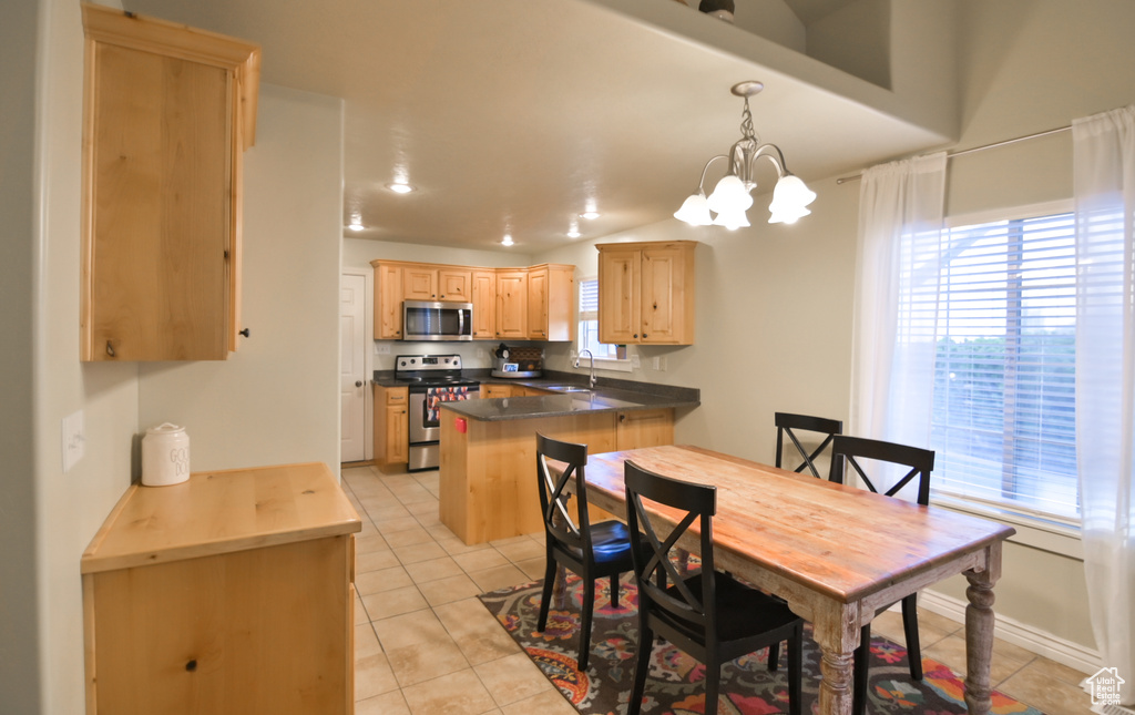 Dining room featuring light tile patterned floors, plenty of natural light, and an inviting chandelier