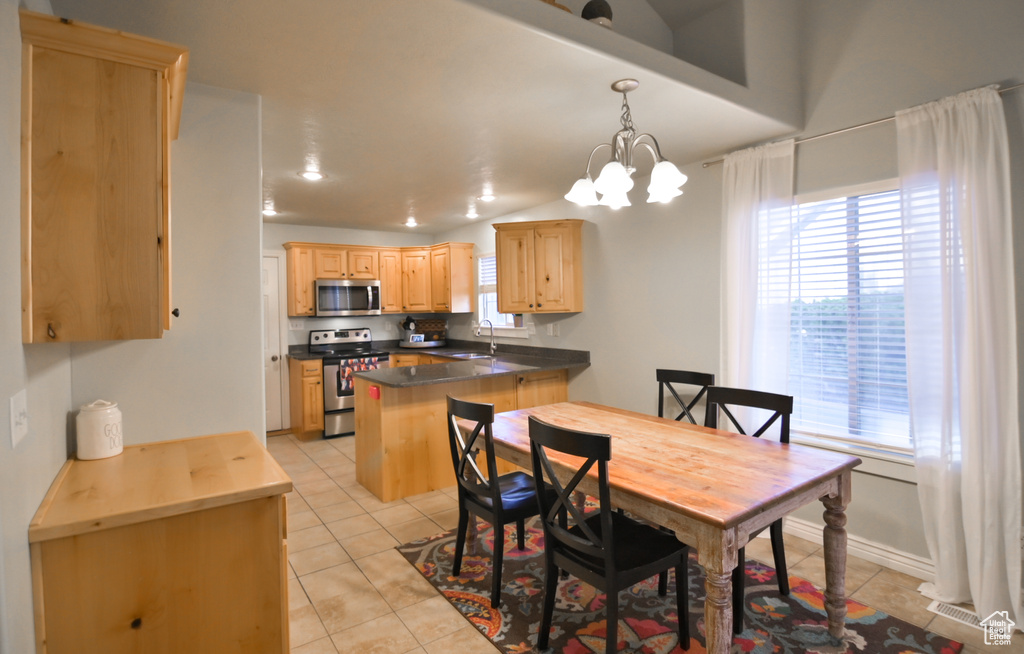 Dining room with visible vents, baseboards, an inviting chandelier, light tile patterned floors, and lofted ceiling