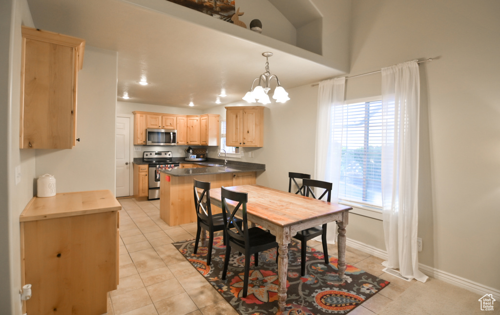 Dining area with light tile patterned floors, baseboards, and a chandelier