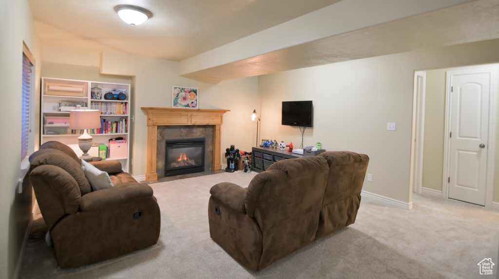 Carpeted living room with a fireplace and baseboards