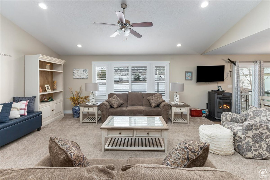 Living room featuring carpet, lofted ceiling, recessed lighting, and a ceiling fan