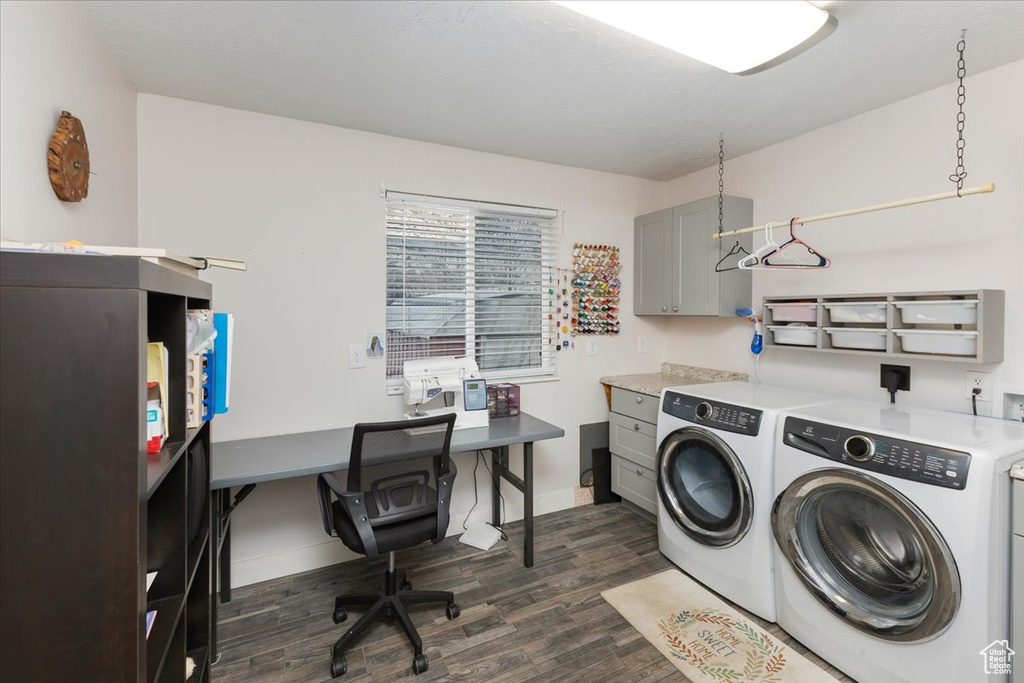 Clothes washing area featuring cabinet space, dark wood-style floors, washing machine and dryer, and baseboards