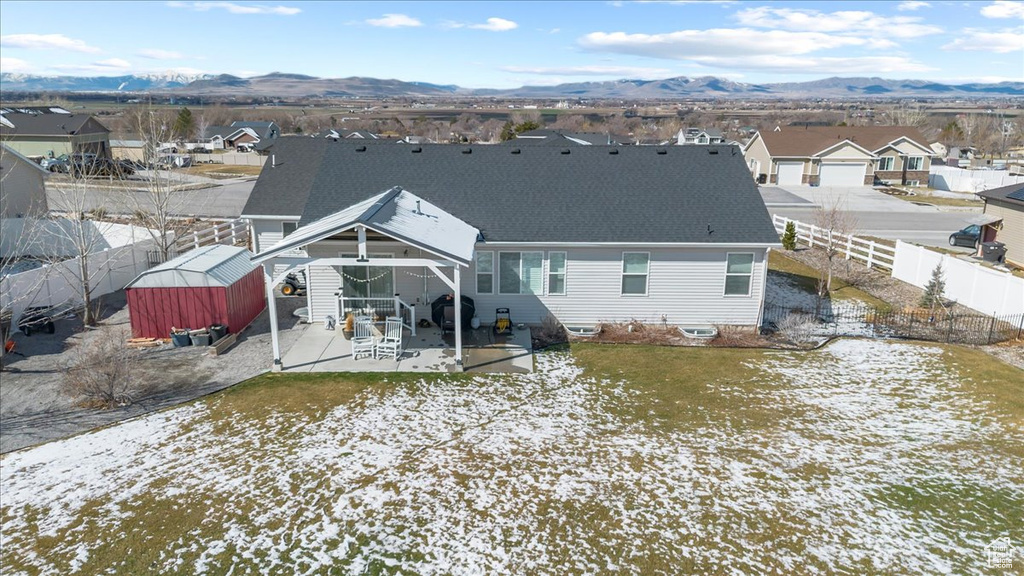Rear view of property featuring a patio area, a residential view, a mountain view, and a fenced backyard