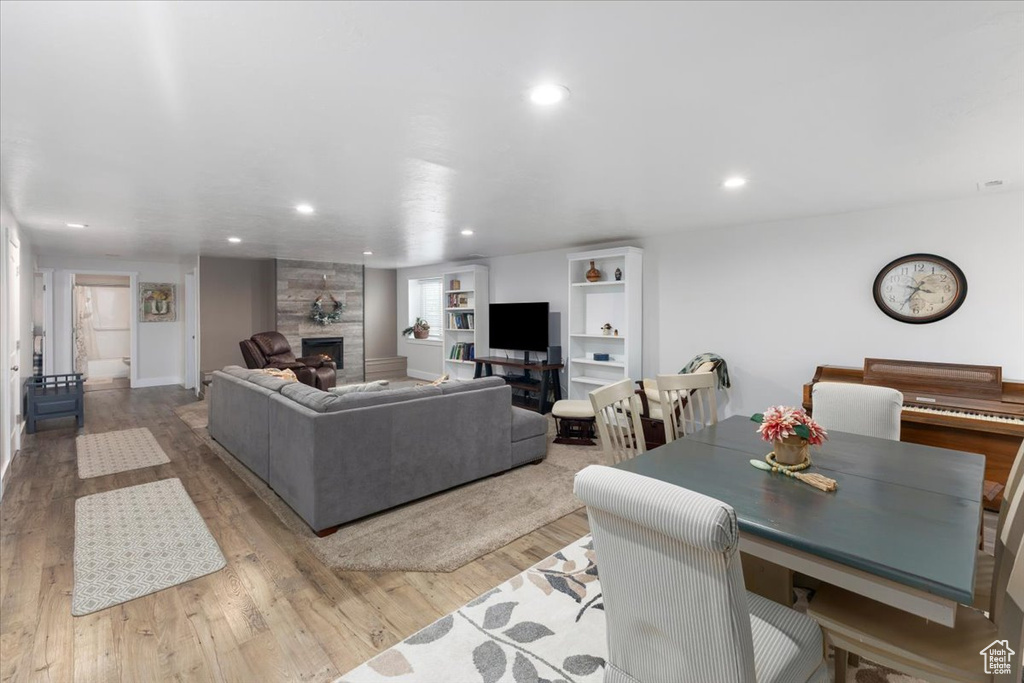 Living area featuring recessed lighting, a fireplace, and wood finished floors