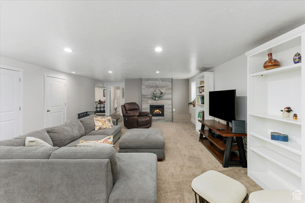 Living area with recessed lighting, a fireplace, and carpet floors