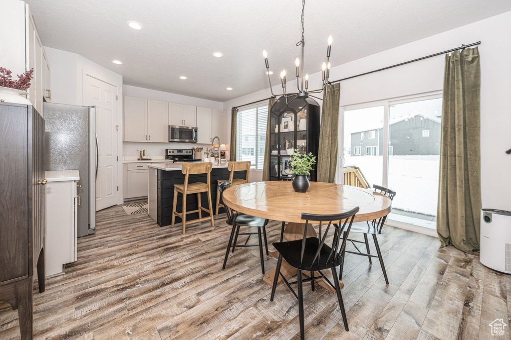 Dining space with recessed lighting and light wood-style floors