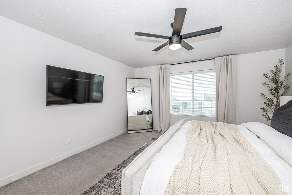 Bedroom featuring baseboards, carpet, and a ceiling fan