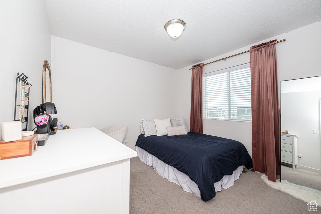 Bedroom featuring light carpet