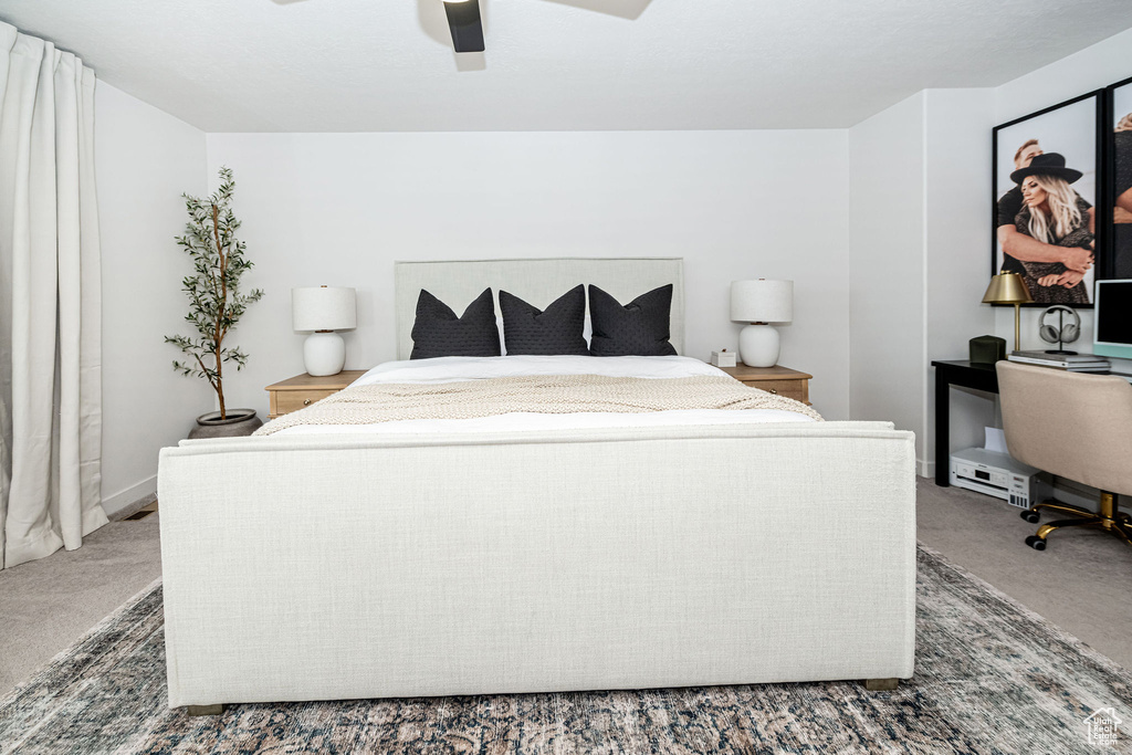 Bedroom with a ceiling fan and carpet floors