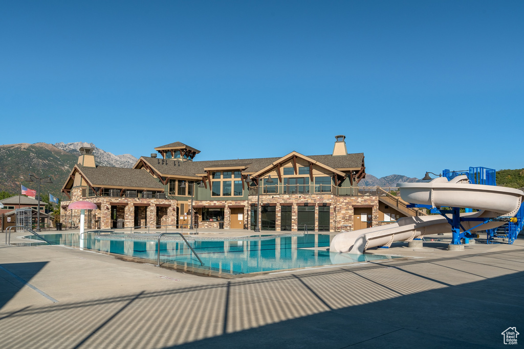 Pool featuring a patio area, a mountain view, and a water slide