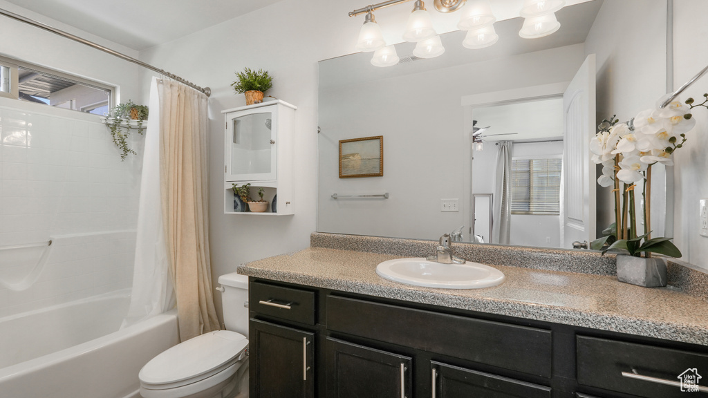Full bath featuring a wealth of natural light, toilet, shower / bath combo, and vanity