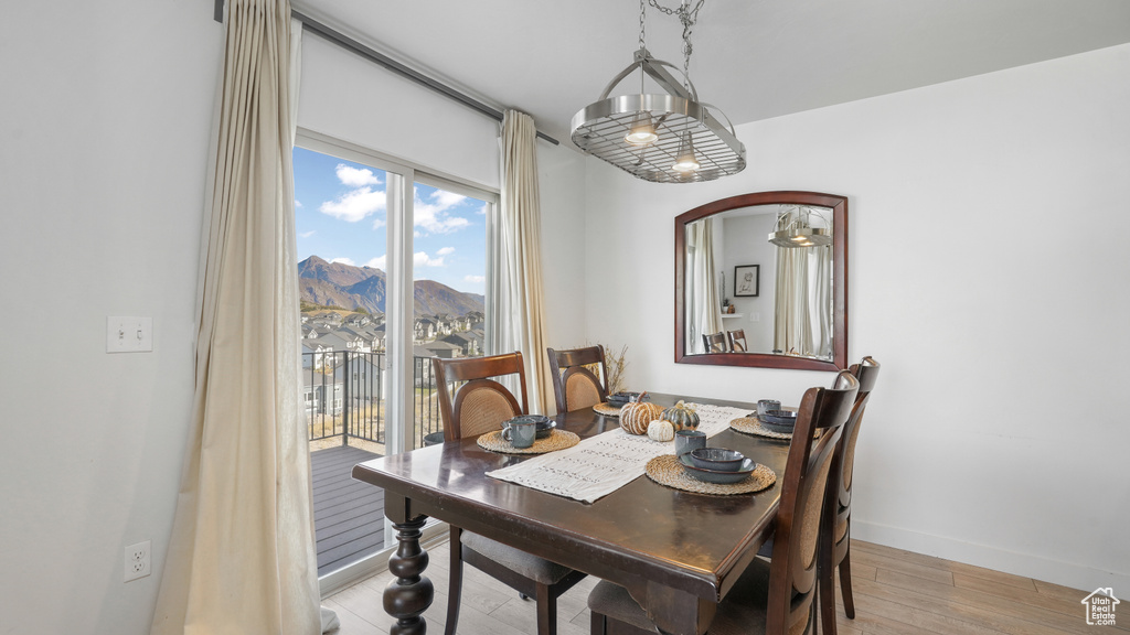 Dining room featuring a mountain view, wood finished floors, baseboards, and arched walkways