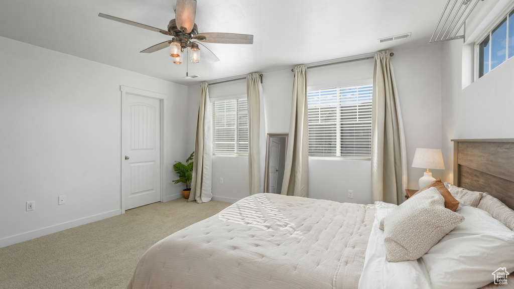 Bedroom featuring ceiling fan, carpet, visible vents, and baseboards