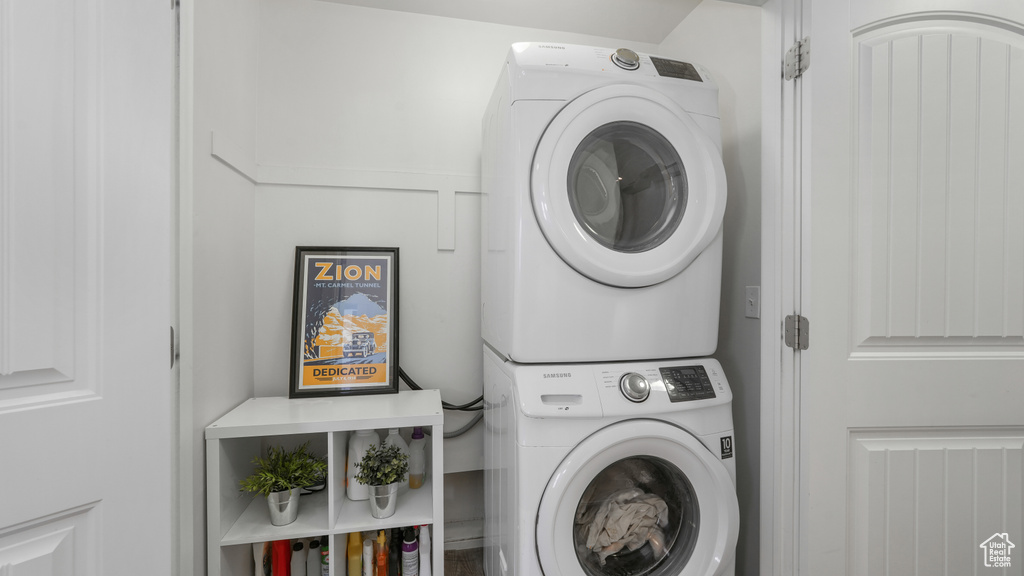 Washroom with stacked washing maching and dryer