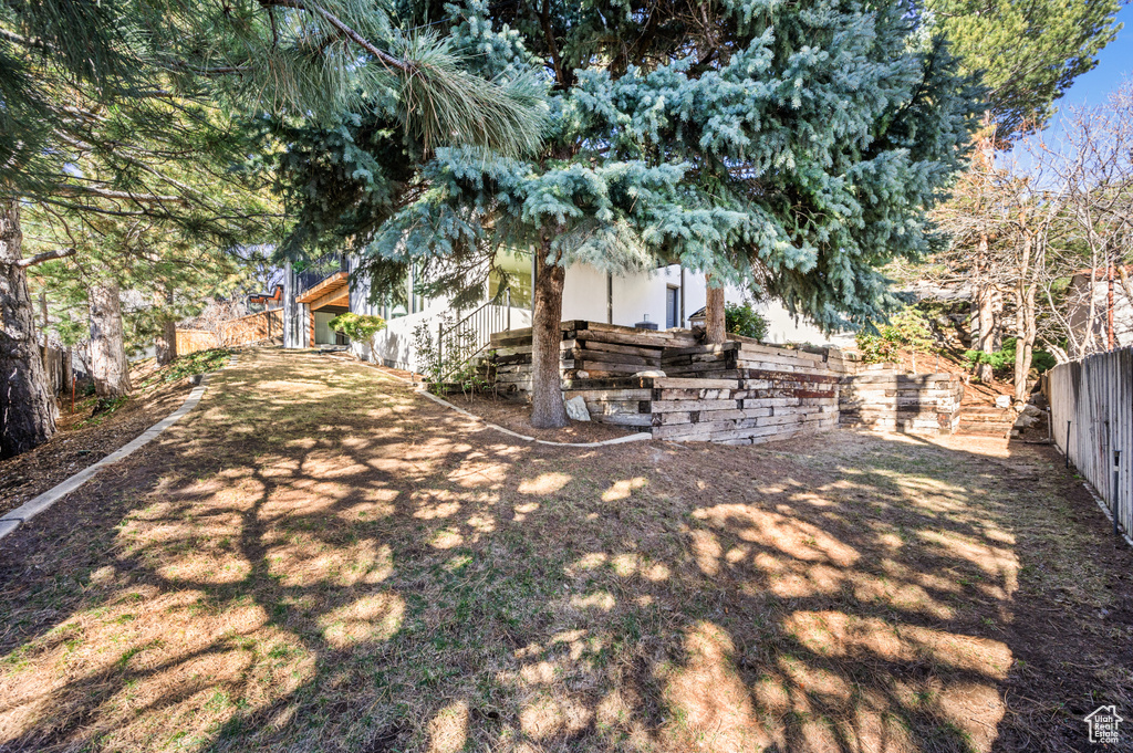 View of yard with stairway and a fenced backyard