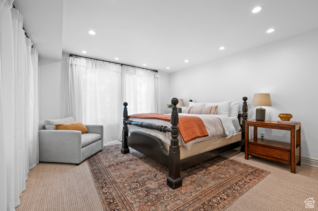 Bedroom featuring light carpet, recessed lighting, and baseboards