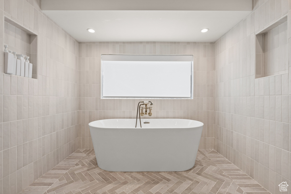 Full bath with recessed lighting, a freestanding tub, and tile patterned flooring
