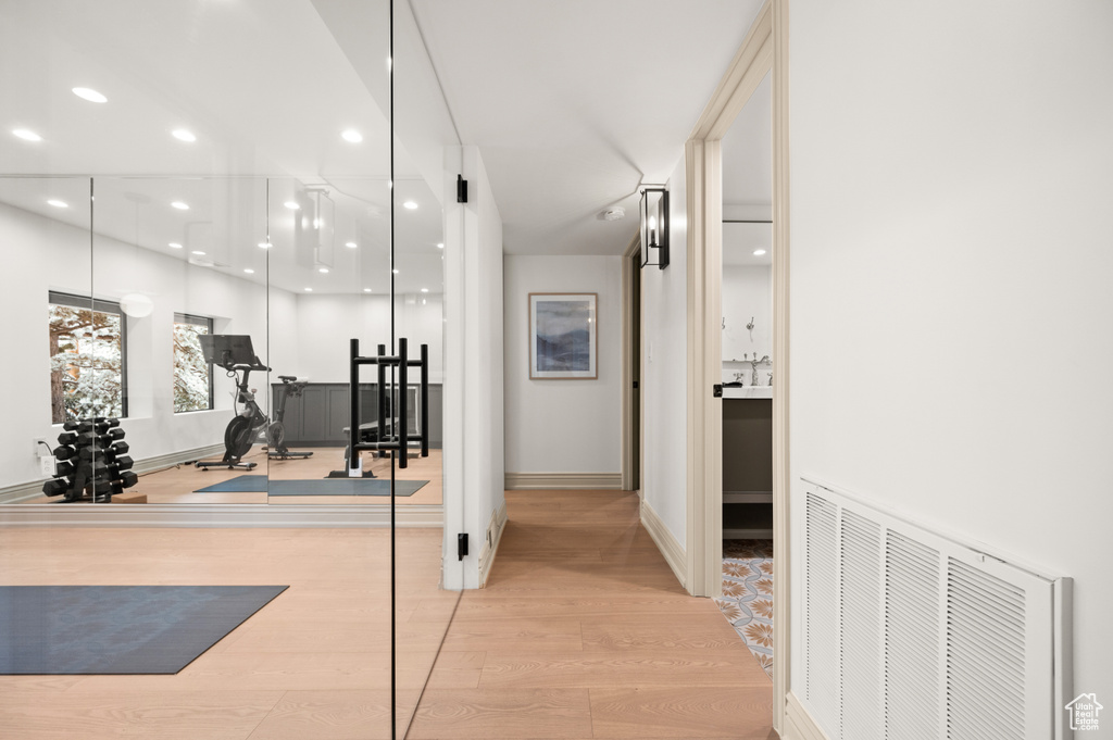 Workout area featuring recessed lighting, wood finished floors, visible vents, and baseboards