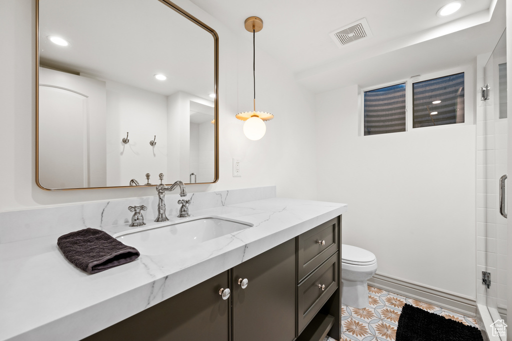 Bathroom featuring vanity, toilet, recessed lighting, and visible vents
