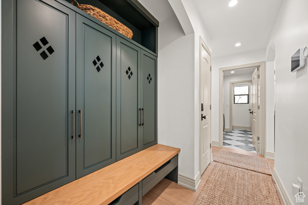 Mudroom featuring arched walkways, recessed lighting, and baseboards