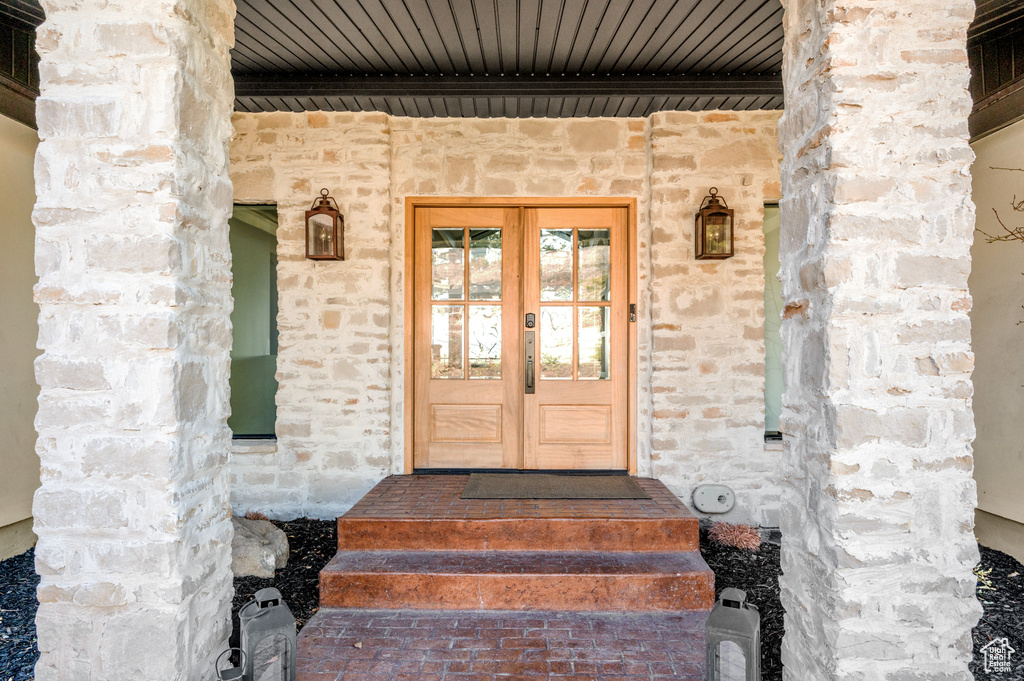 Entrance to property with french doors and stone siding