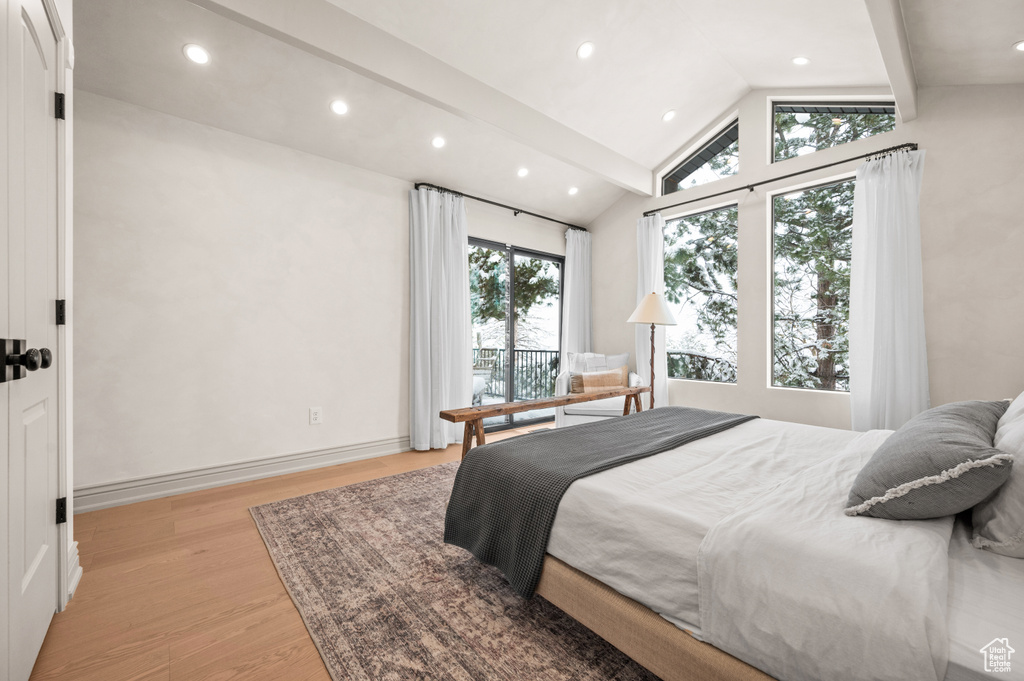 Bedroom featuring recessed lighting, baseboards, vaulted ceiling with beams, and light wood finished floors