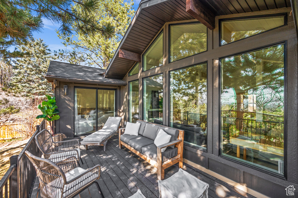 Wooden deck featuring outdoor lounge area