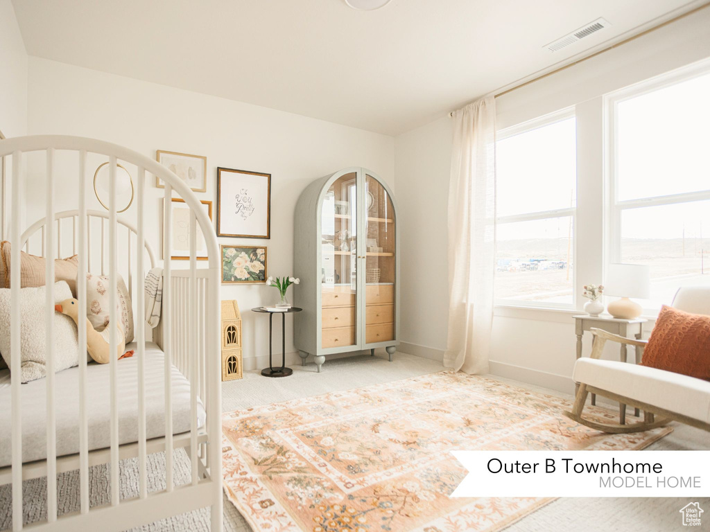 Bedroom featuring carpet flooring, baseboards, and visible vents