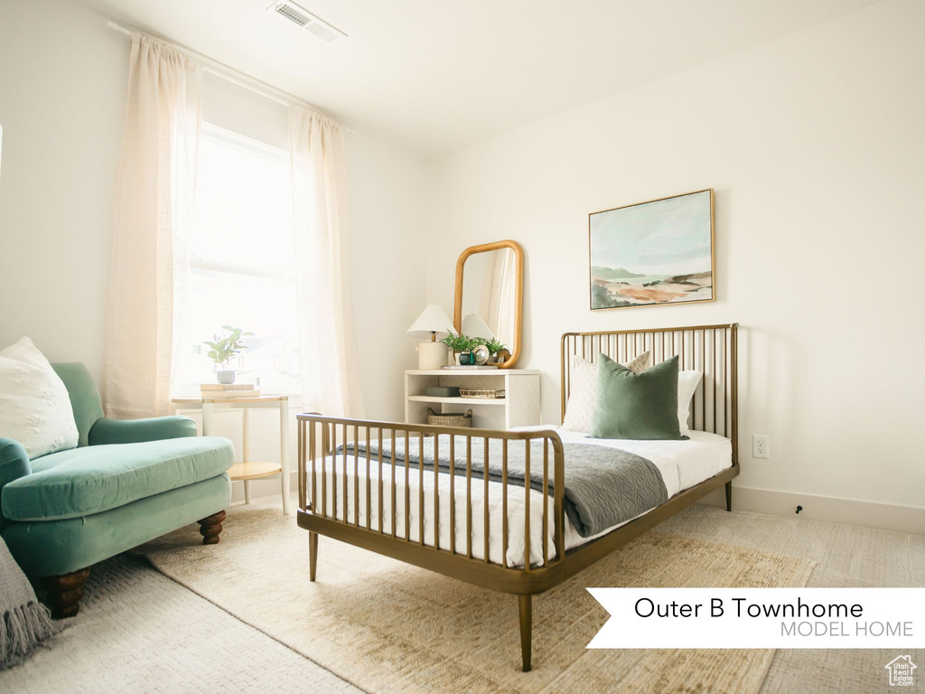 Carpeted bedroom with visible vents and baseboards