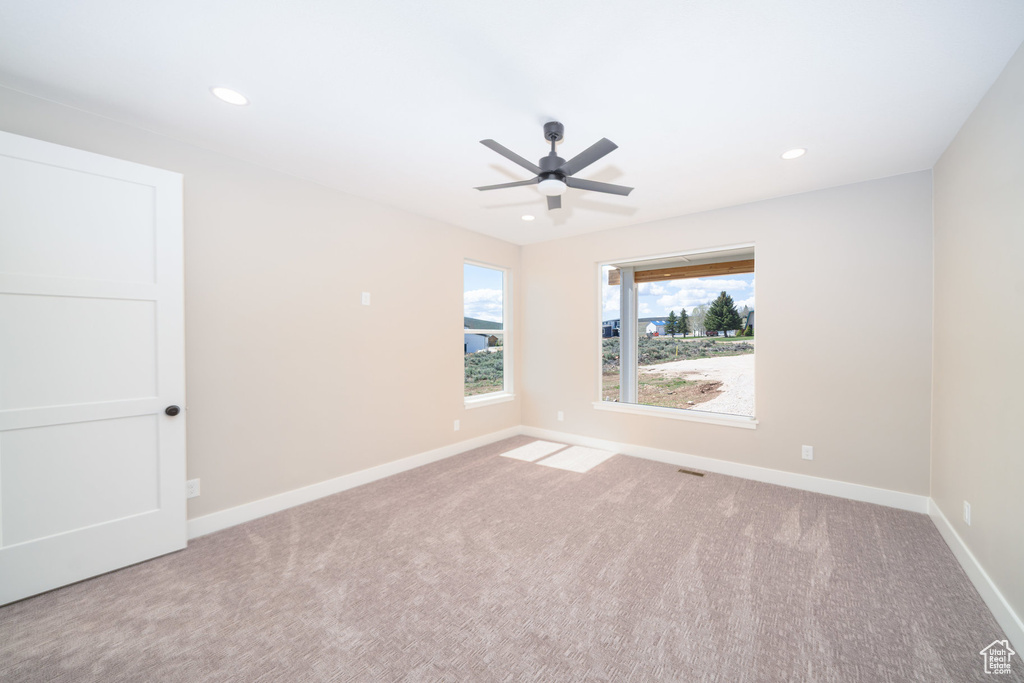 Carpeted spare room with baseboards, a ceiling fan, and recessed lighting